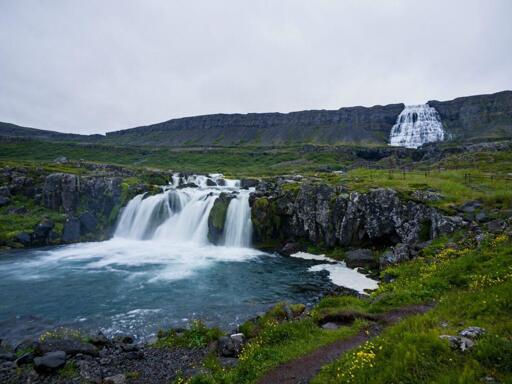 A waterfall terminates in a pool, source visible high above